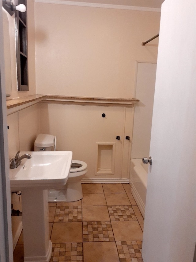 bathroom with ornamental molding, tile patterned flooring, and toilet