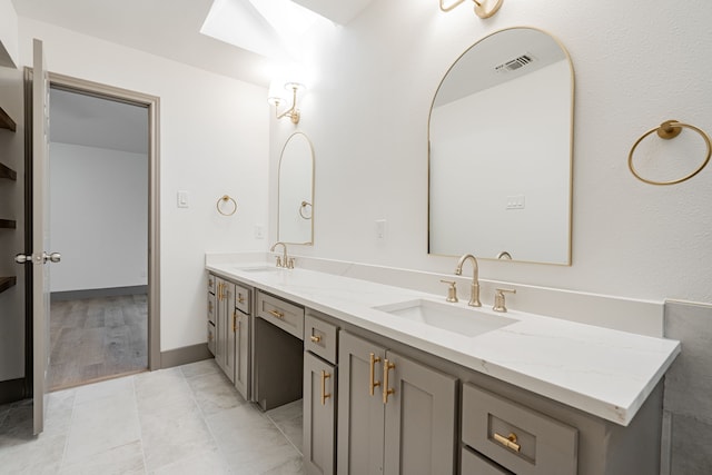 bathroom with tile patterned floors and vanity