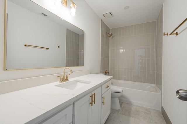 full bathroom with tiled shower / bath, vanity, and toilet