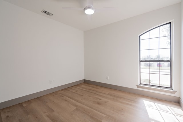 spare room featuring ceiling fan, plenty of natural light, and light hardwood / wood-style floors