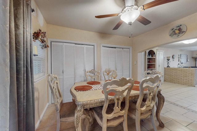 tiled dining area featuring ceiling fan