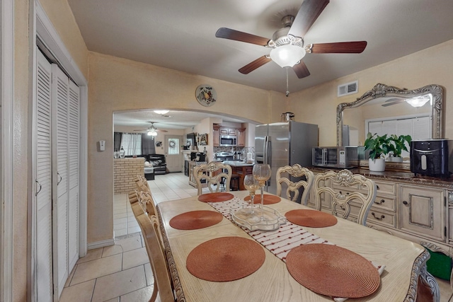 dining room with light tile patterned floors and ceiling fan