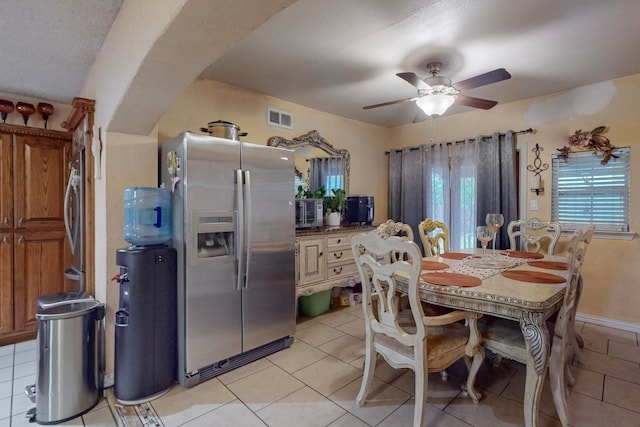 dining area featuring washer / clothes dryer, light tile patterned floors, and ceiling fan