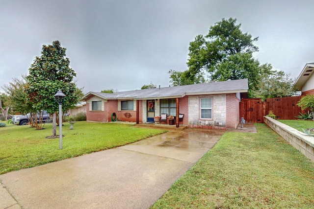 ranch-style home with a front lawn