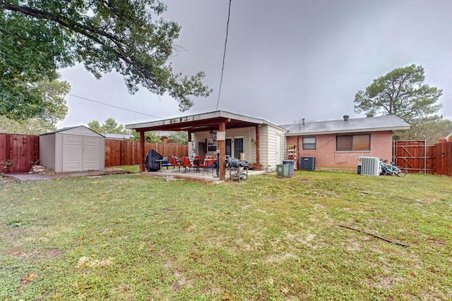 rear view of property featuring a lawn, central AC, a storage shed, and a patio area