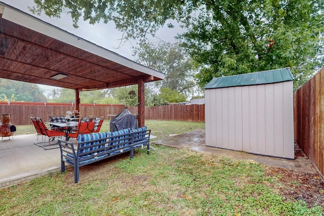 view of yard with a storage shed and a patio area