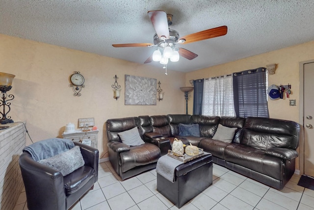 living room featuring a textured ceiling, ceiling fan, and light tile patterned floors