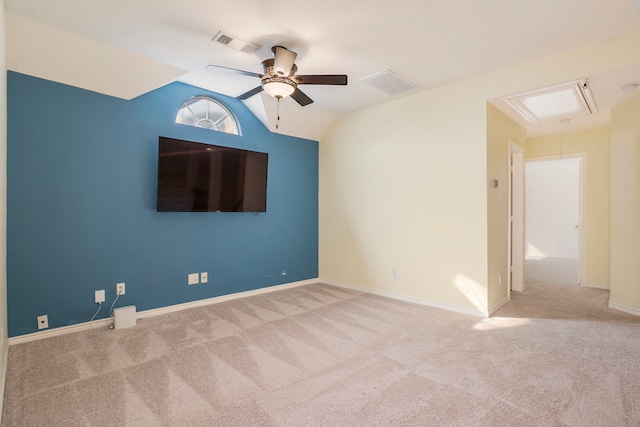 spare room featuring vaulted ceiling, light colored carpet, and ceiling fan