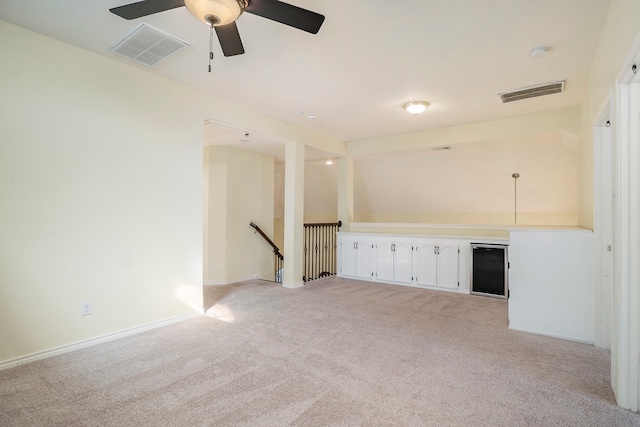 unfurnished room with ceiling fan and light colored carpet