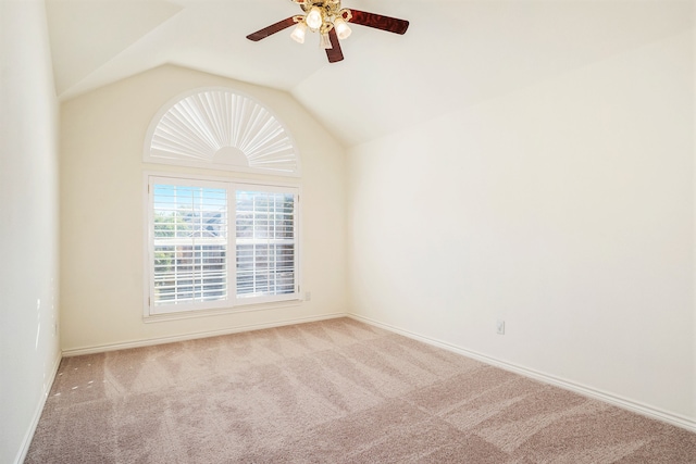 spare room with lofted ceiling, light colored carpet, and ceiling fan