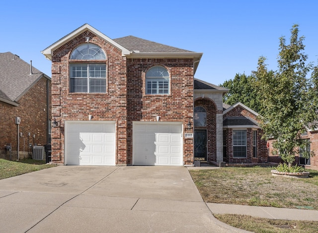 view of front property with a garage, central AC unit, and a front lawn