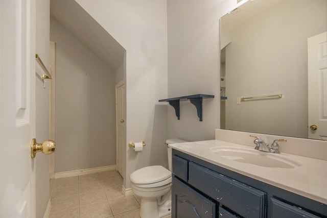 bathroom featuring tile patterned flooring, vanity, and toilet