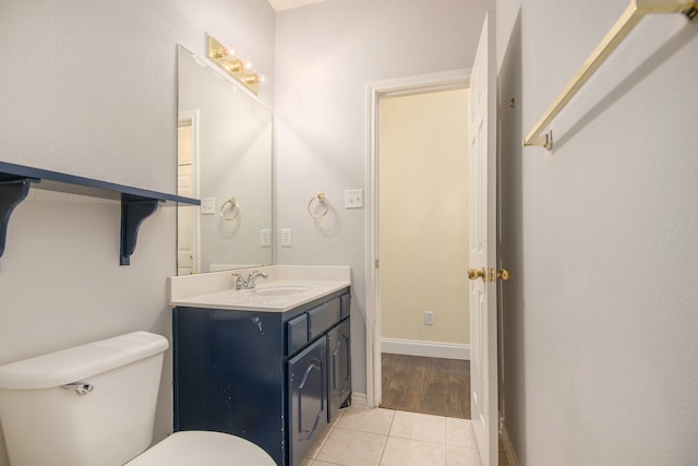 bathroom with tile patterned floors, toilet, and vanity