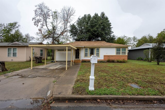 ranch-style house featuring a carport and a front yard