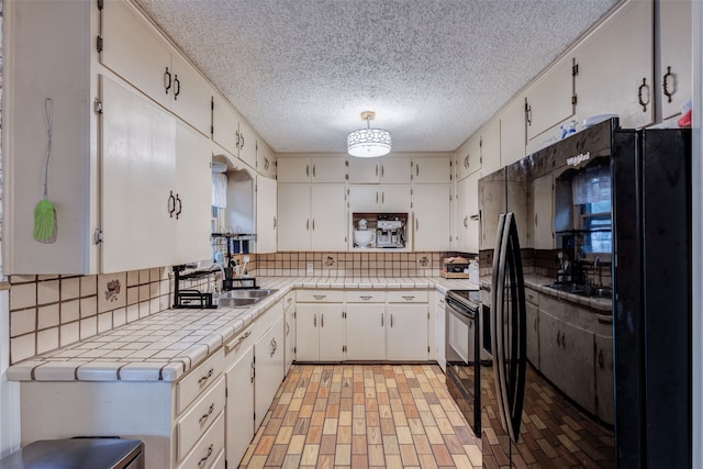 kitchen featuring white cabinetry and sink