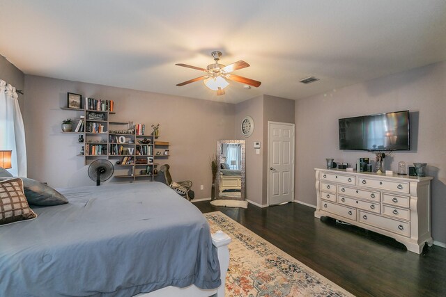 bedroom with ceiling fan and dark hardwood / wood-style floors