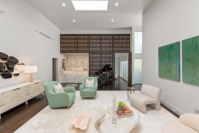 living room with a skylight and hardwood / wood-style floors