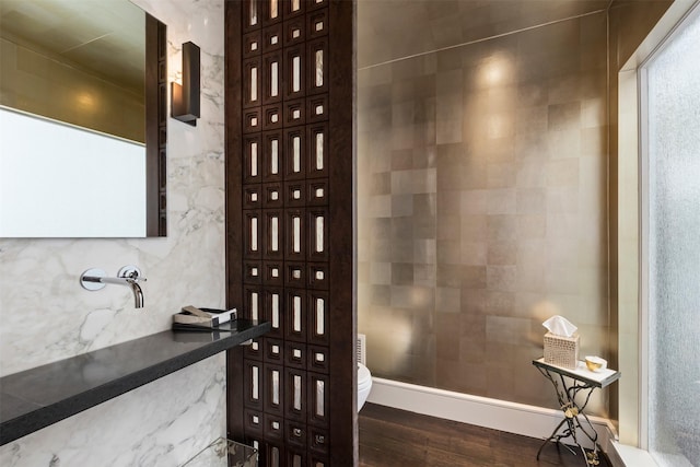 bathroom featuring wood-type flooring and toilet