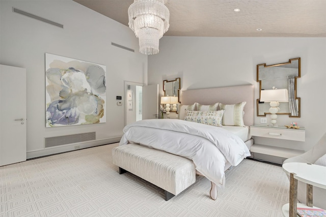 bedroom with a notable chandelier and vaulted ceiling