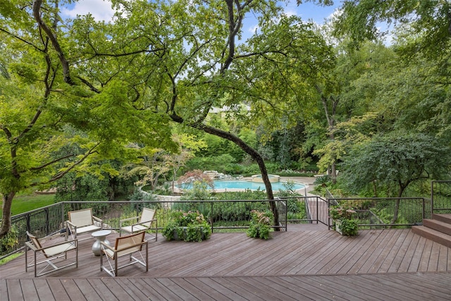 wooden terrace with a fenced in pool