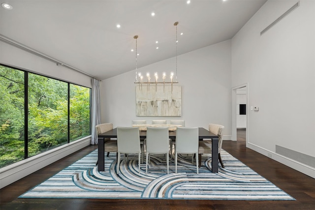 dining space with high vaulted ceiling, a chandelier, and dark hardwood / wood-style floors