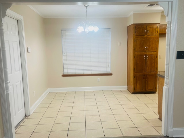 unfurnished dining area with ornamental molding, light tile patterned flooring, and an inviting chandelier