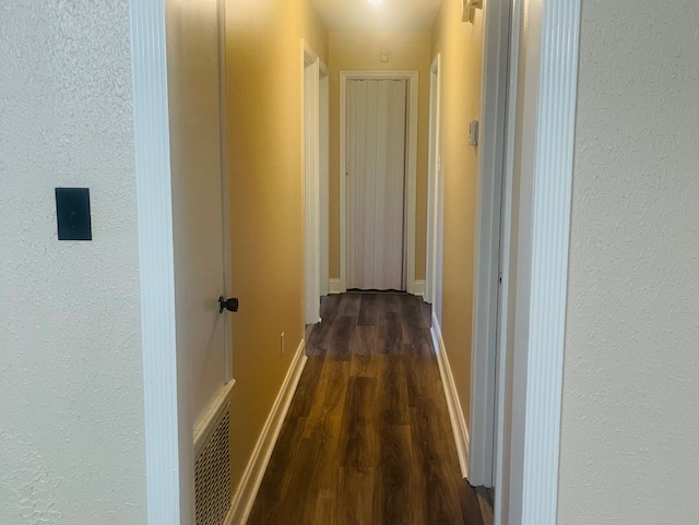 hall with dark wood-type flooring