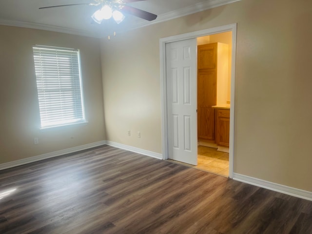 spare room with ceiling fan, crown molding, and dark hardwood / wood-style flooring