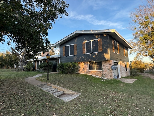 view of side of home with a lawn