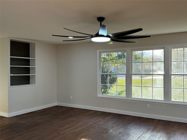 unfurnished room with ceiling fan and dark hardwood / wood-style floors