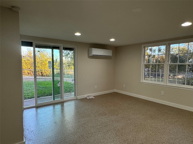 unfurnished room with a wall unit AC