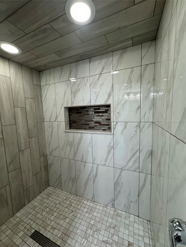 bathroom with a tile shower