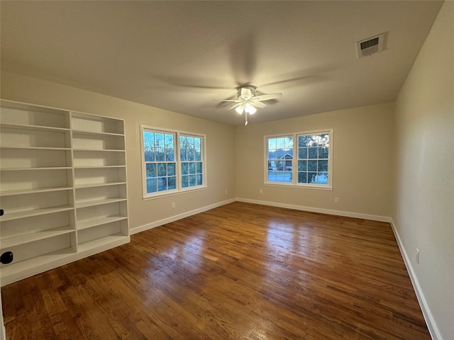 unfurnished room featuring dark wood-type flooring and ceiling fan