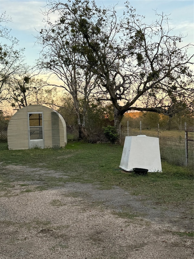 yard at dusk with a storage unit