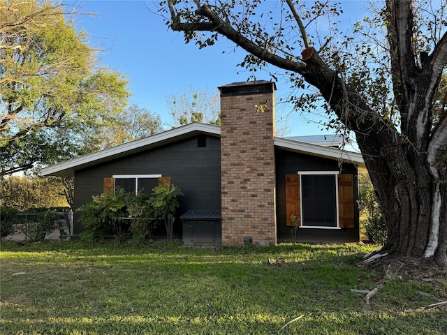 back of property featuring a lawn