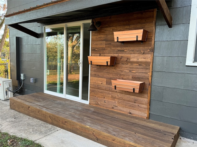 view of exterior entry featuring ac unit