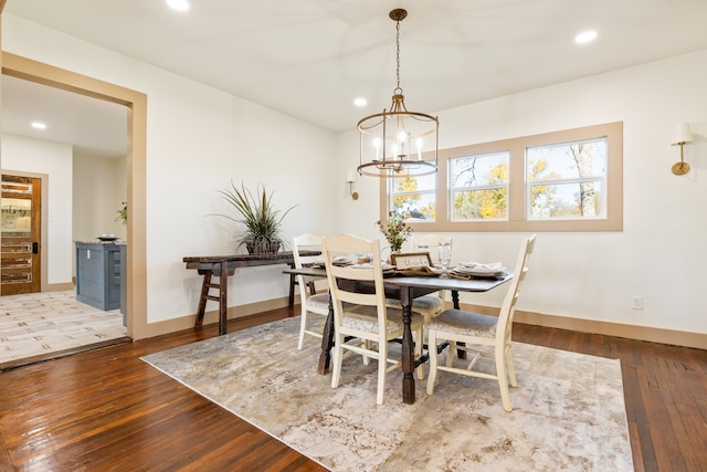 dining area featuring a notable chandelier and dark hardwood / wood-style floors