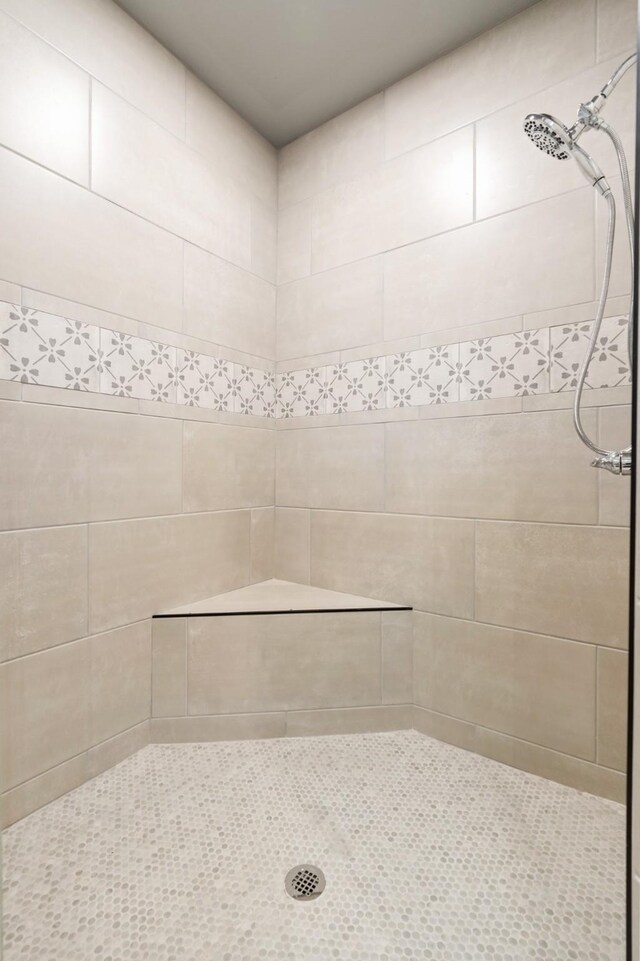 bathroom with tiled shower