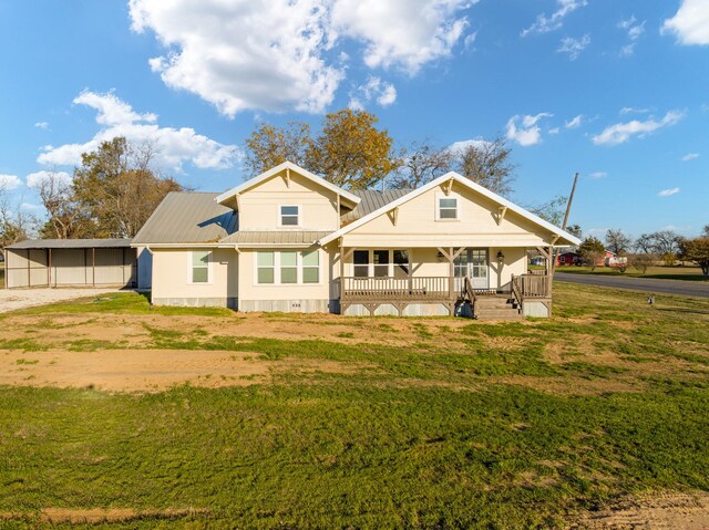 rear view of house with a yard, a carport, and a porch