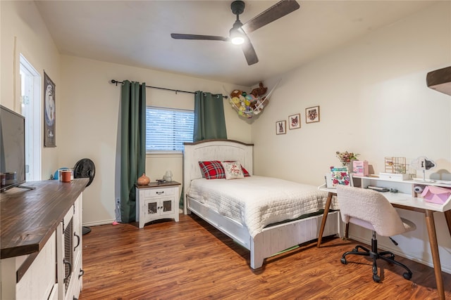 bedroom featuring dark hardwood / wood-style floors and ceiling fan