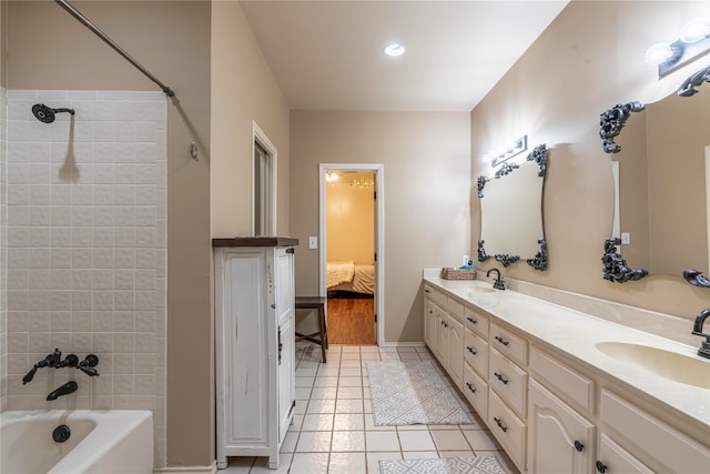 bathroom with tiled shower / bath, vanity, and tile patterned flooring