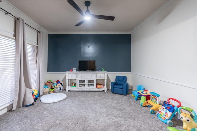 game room featuring ceiling fan, a healthy amount of sunlight, carpet flooring, and ornamental molding