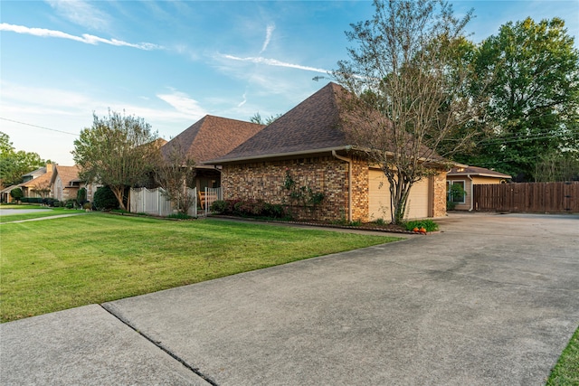 ranch-style home featuring a garage and a front lawn