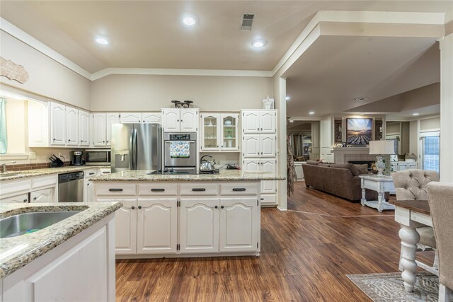 kitchen with light stone countertops, white cabinetry, and appliances with stainless steel finishes