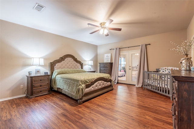 bedroom featuring dark hardwood / wood-style flooring, french doors, and ceiling fan