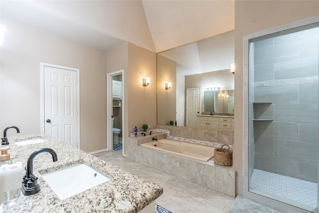 full bathroom with toilet, lofted ceiling, separate shower and tub, and vanity