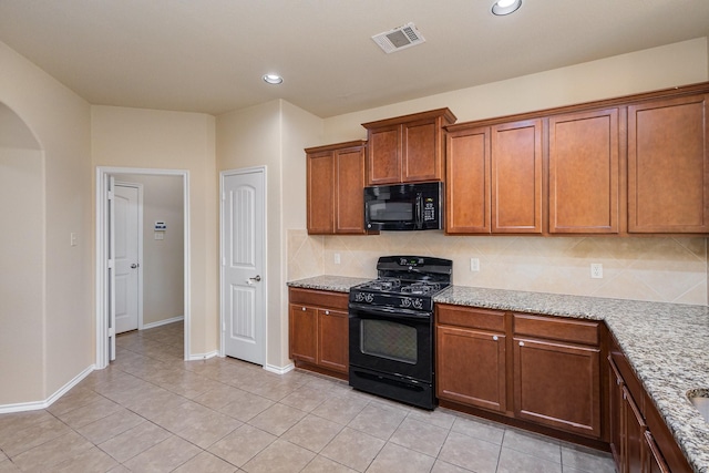 kitchen with black appliances, decorative backsplash, light stone countertops, and light tile patterned floors