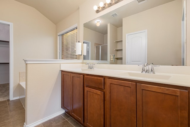 bathroom featuring plus walk in shower, vanity, vaulted ceiling, and tile patterned floors