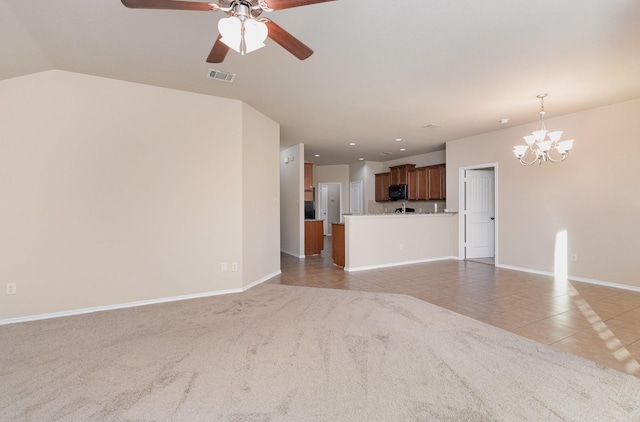 unfurnished living room featuring lofted ceiling, light carpet, and ceiling fan with notable chandelier