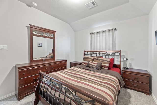 carpeted bedroom featuring lofted ceiling and a textured ceiling